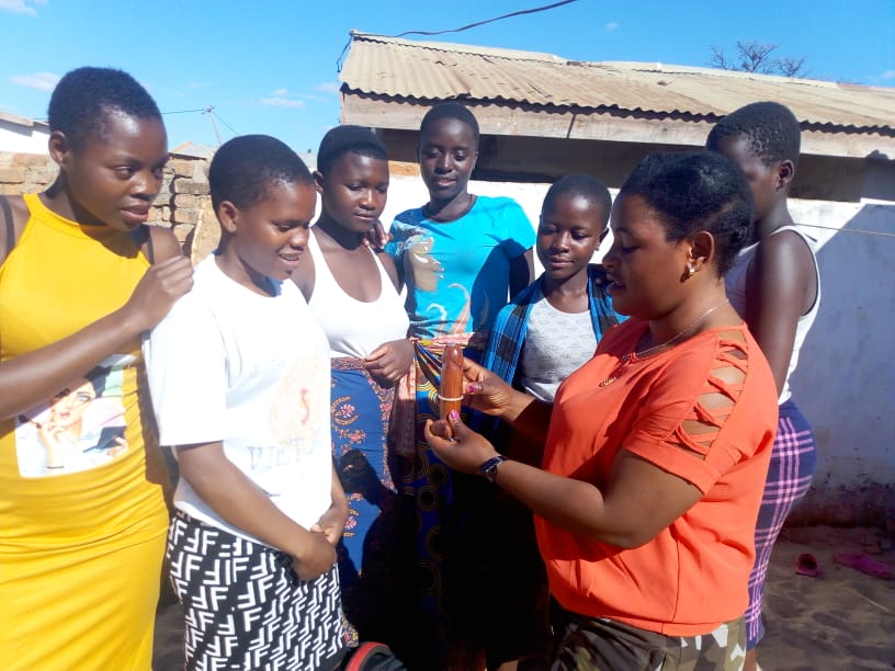 Adolescent Girls and Young Women (AGYW) being taken through condom demonstration sessions